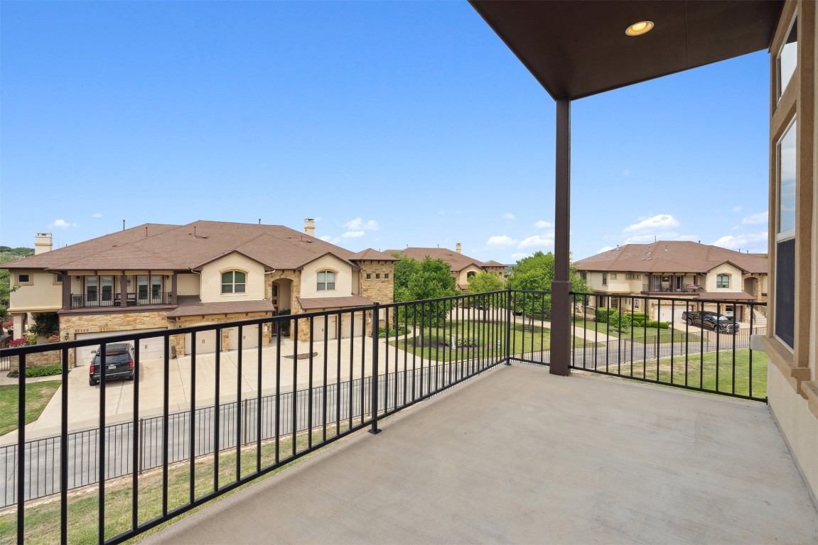 111 ANTONIO Way, Unit 5A Austin, TX 78734 - Photo 21 of 40 a view of a white house with a small yard