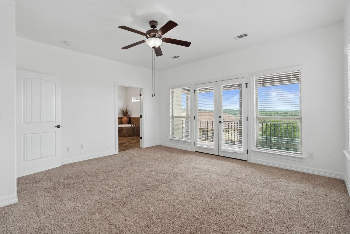 111 ANTONIO Way, Unit 5A Austin, TX 78734 - Photo 23 of 40 a view of an empty room with a window and a kitchen