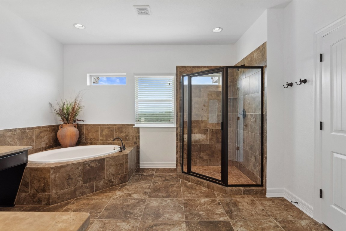 111 ANTONIO Way, Unit 5A Austin, TX 78734 - Photo 26 of 40 a living room with furniture and a glass door shower