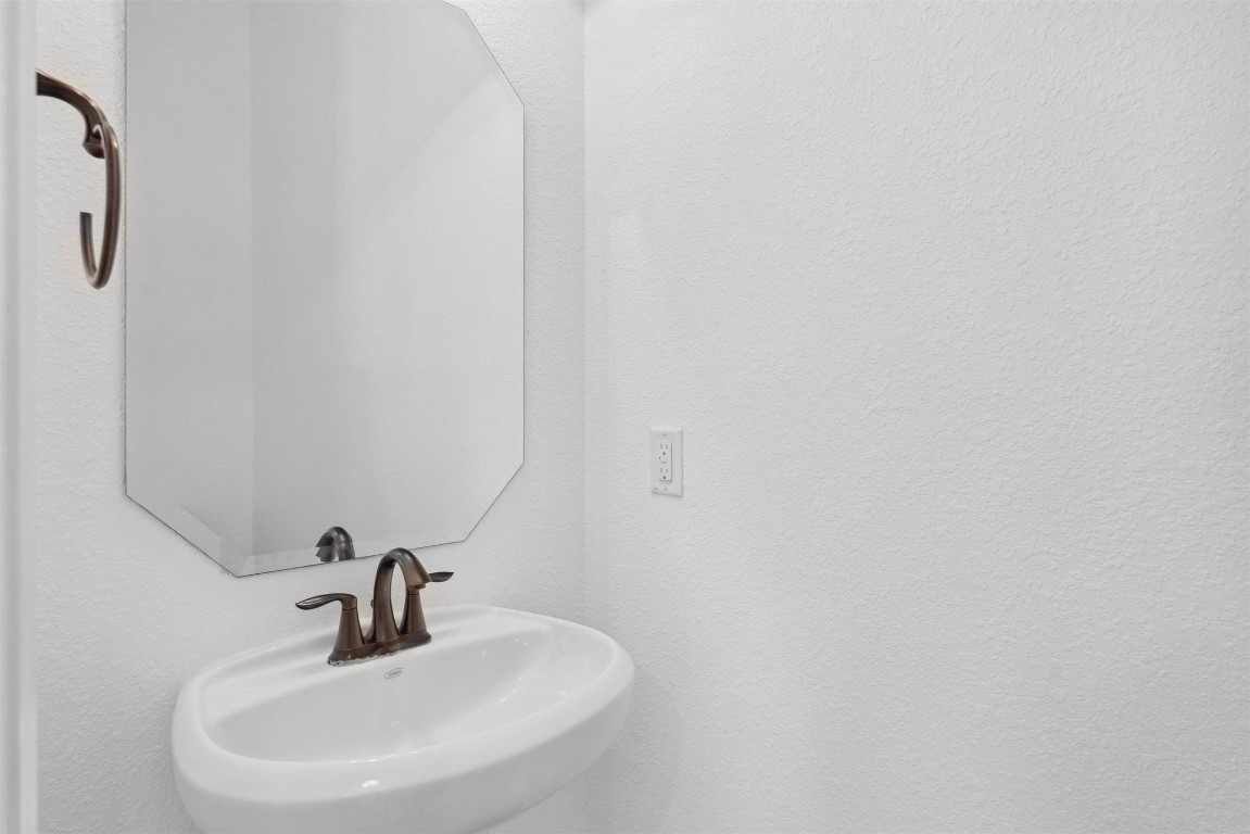 111 ANTONIO Way, Unit 5A Austin, TX 78734 - Photo 34 of 40 a bathroom with a sink and mirror