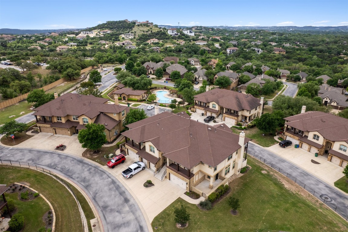 111 ANTONIO Way, Unit 5A Austin, TX 78734 - Photo 36 of 40 an aerial view of a house with swimming pool and mountains