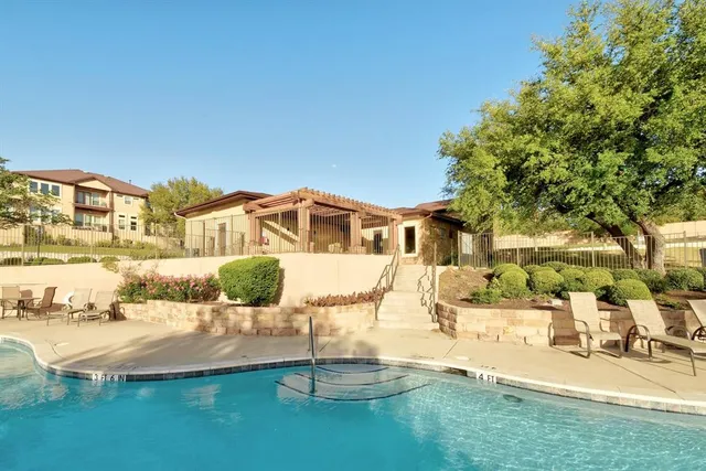 a view of a swimming pool with a patio