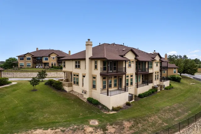 a aerial view of a house with a yard table and chairs
