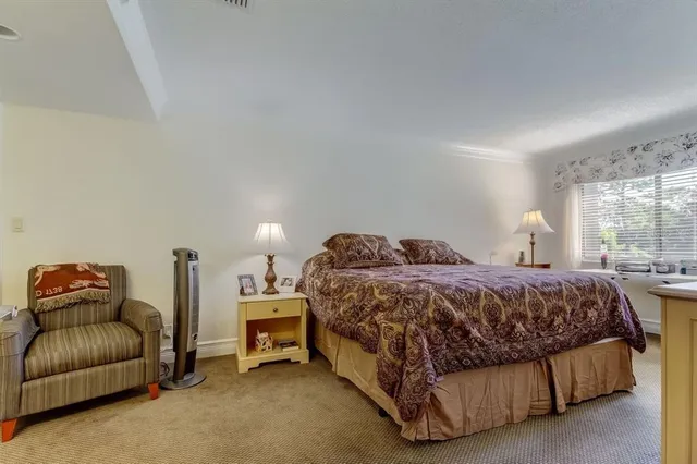 a spacious bedroom with a bed and a couch