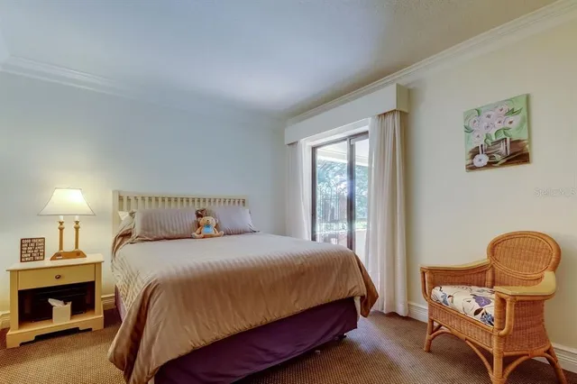 a bedroom with a bed chair and window
