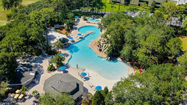 an aerial view of a house with a yard swimming pool outdoor seating and yard