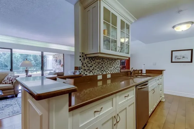 a kitchen with a sink and a stove top oven