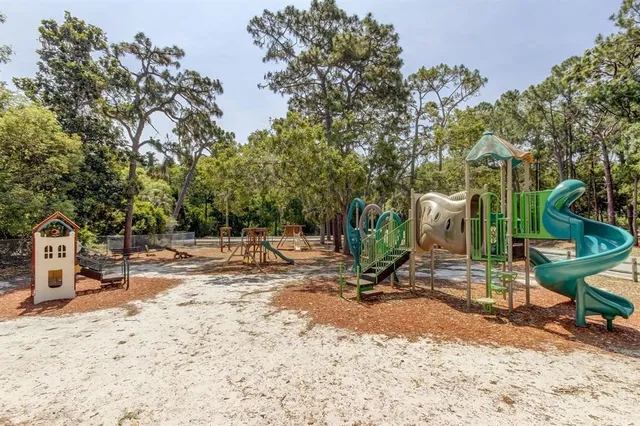 a view of backyard with wooden fence