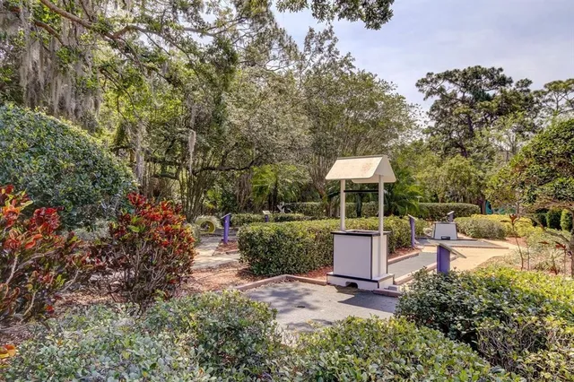 a backyard of a house with a fountain and trees