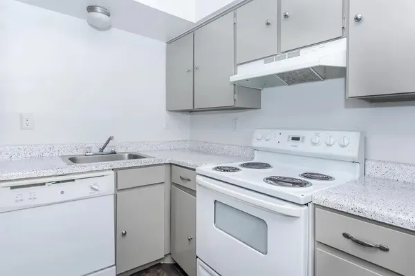 a bathroom with a granite countertop sink a toilet and bathtub