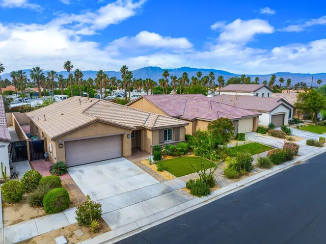a aerial view of a house with a yard and potted plants