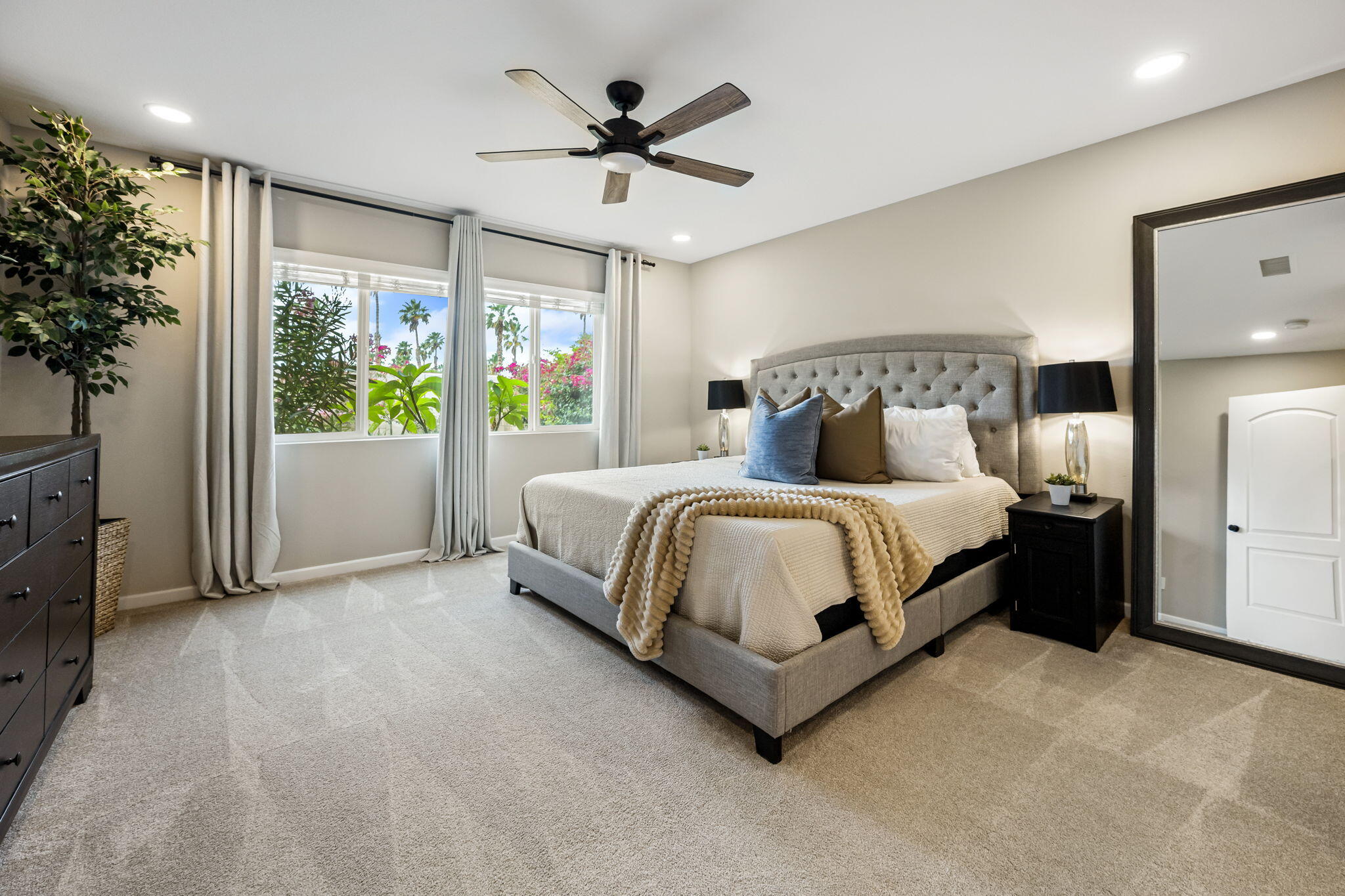 84131 Azzura Way Indio, CA 92203 - Photo 13 of 38 a bedroom with a large bed and a chandelier