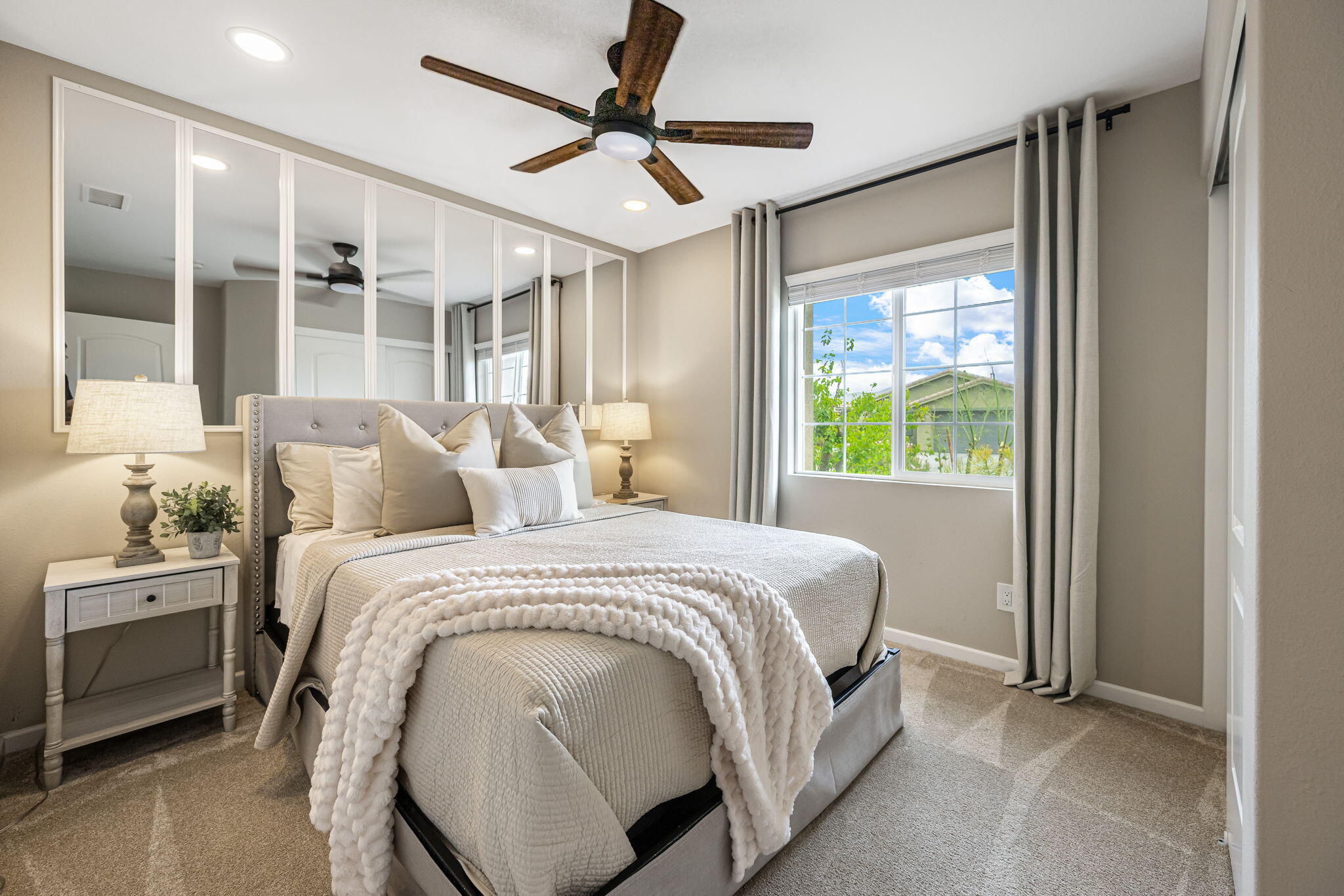 84131 Azzura Way Indio, CA 92203 - Photo 18 of 38 a bedroom with a large bed and a chandelier