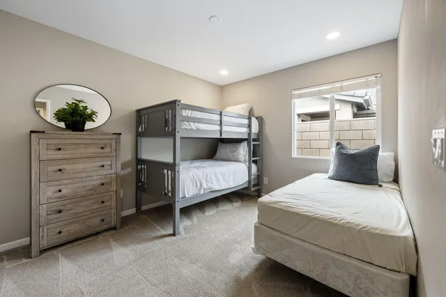 a bedroom with a bed and ceiling fan