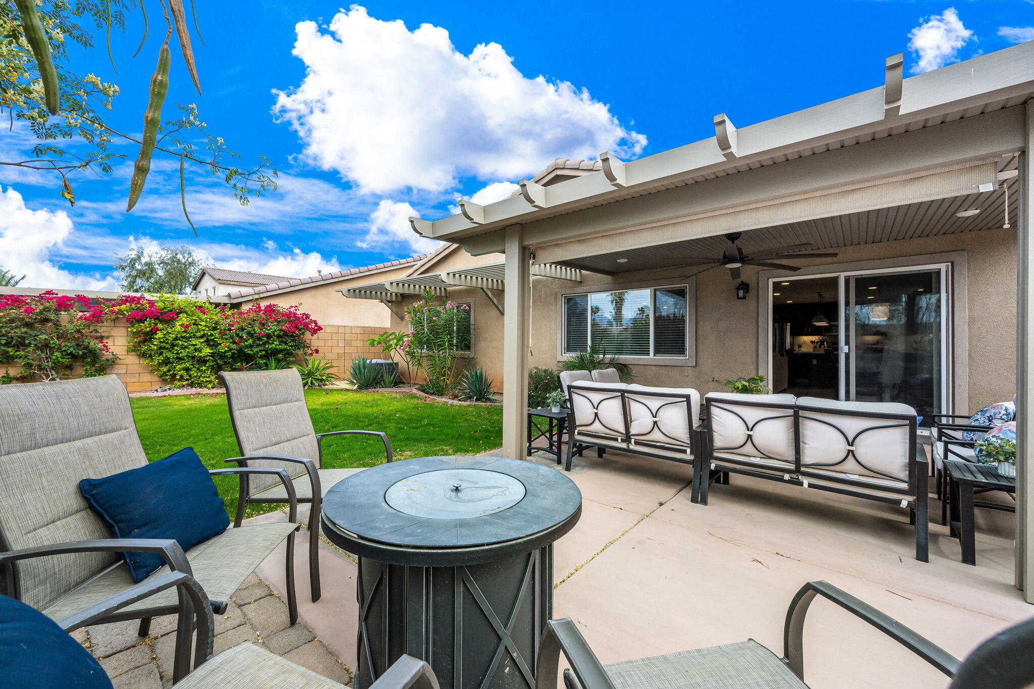 84131 Azzura Way Indio, CA 92203 - Photo 25 of 38 a view of a patio with table and chairs and potted plants