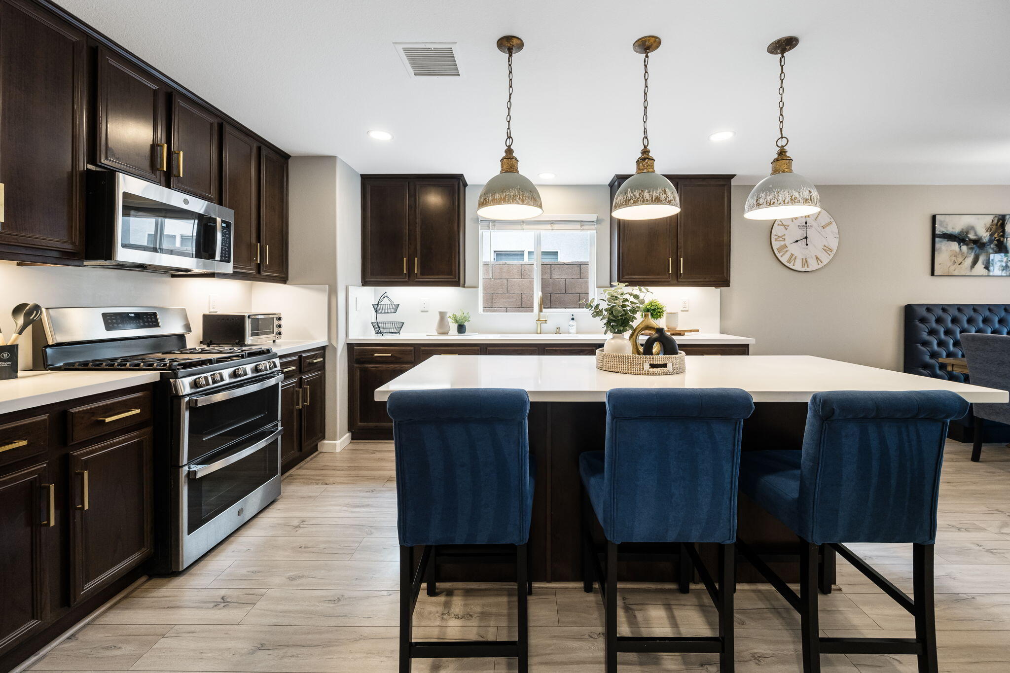 84131 Azzura Way Indio, CA 92203 - Photo 8 of 38 a kitchen with a stove a sink a dining table and chairs