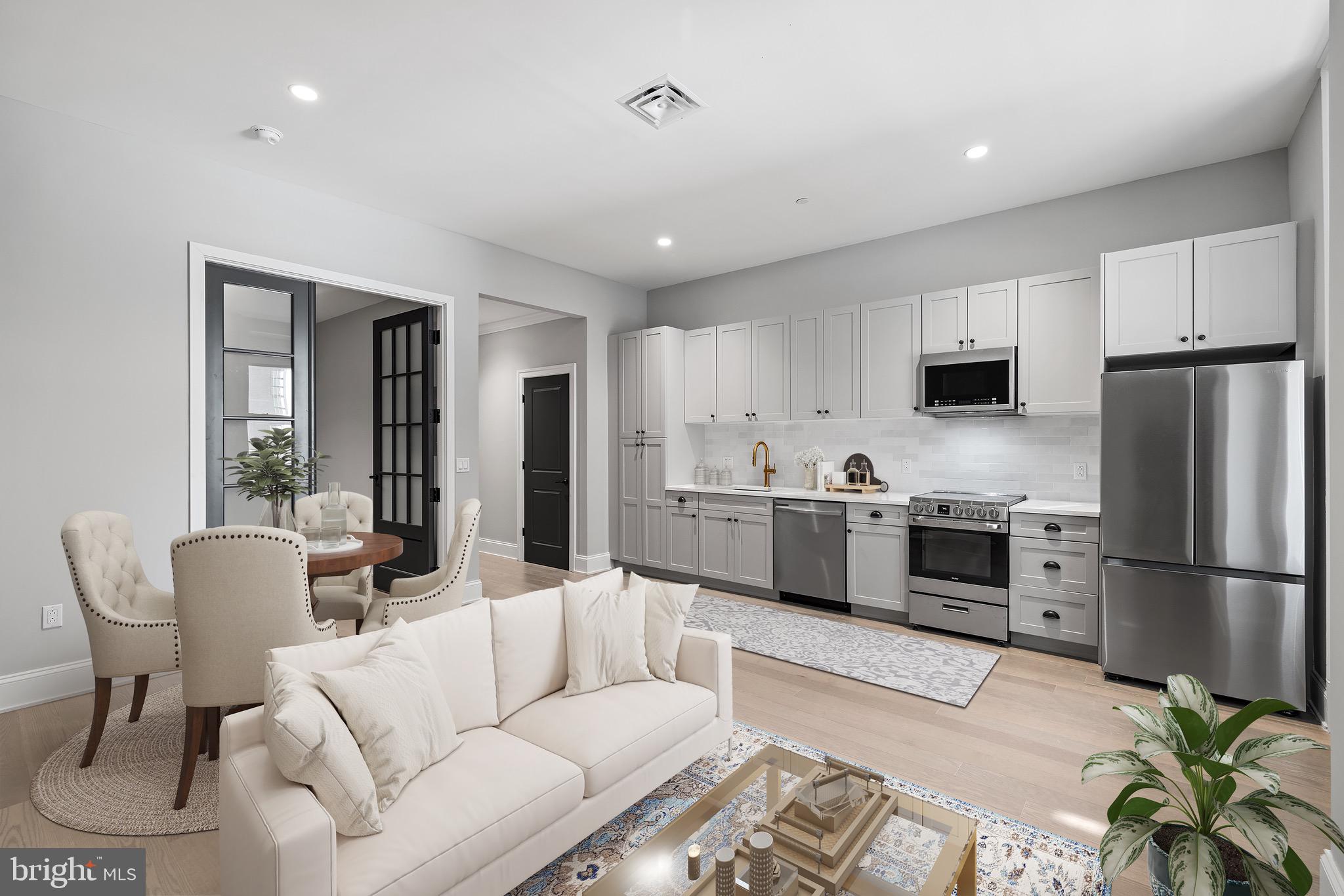 200 South Broad Street, Unit 206 Philadelphia, PA 19102 - Photo 18 of 55 a living room with furniture a refrigerator and a dining table with wooden floor