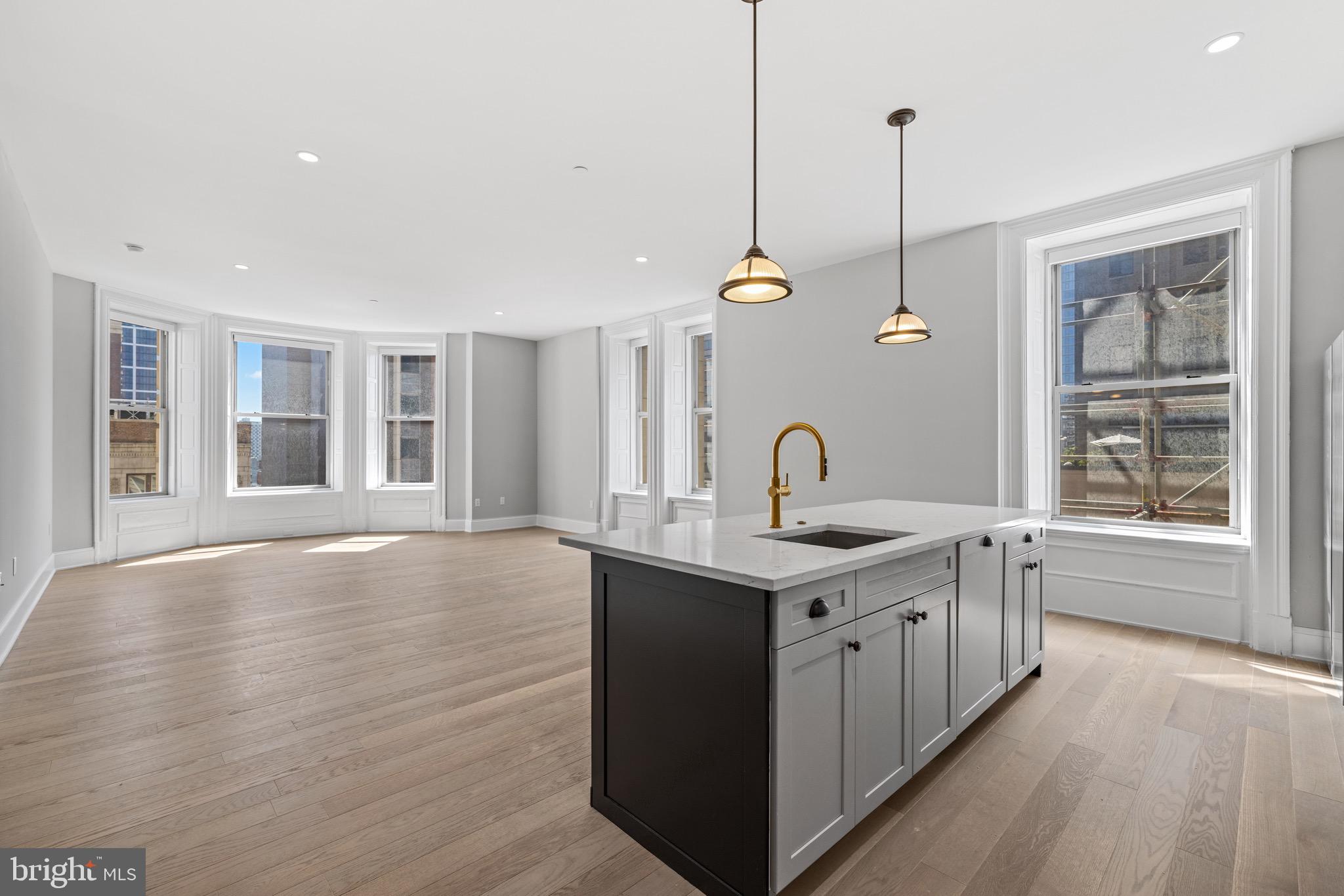 200 South Broad Street, Unit 206 Philadelphia, PA 19102 - Photo 21 of 55 a kitchen with stainless steel appliances granite countertop a sink a stove and a wooden floors