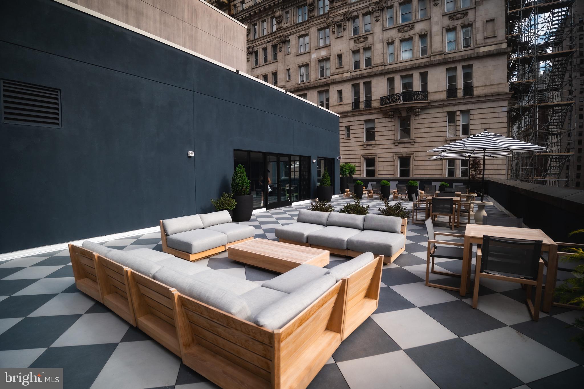 200 South Broad Street, Unit 206 Philadelphia, PA 19102 - Photo 34 of 55 a living room with furniture and a kitchen view