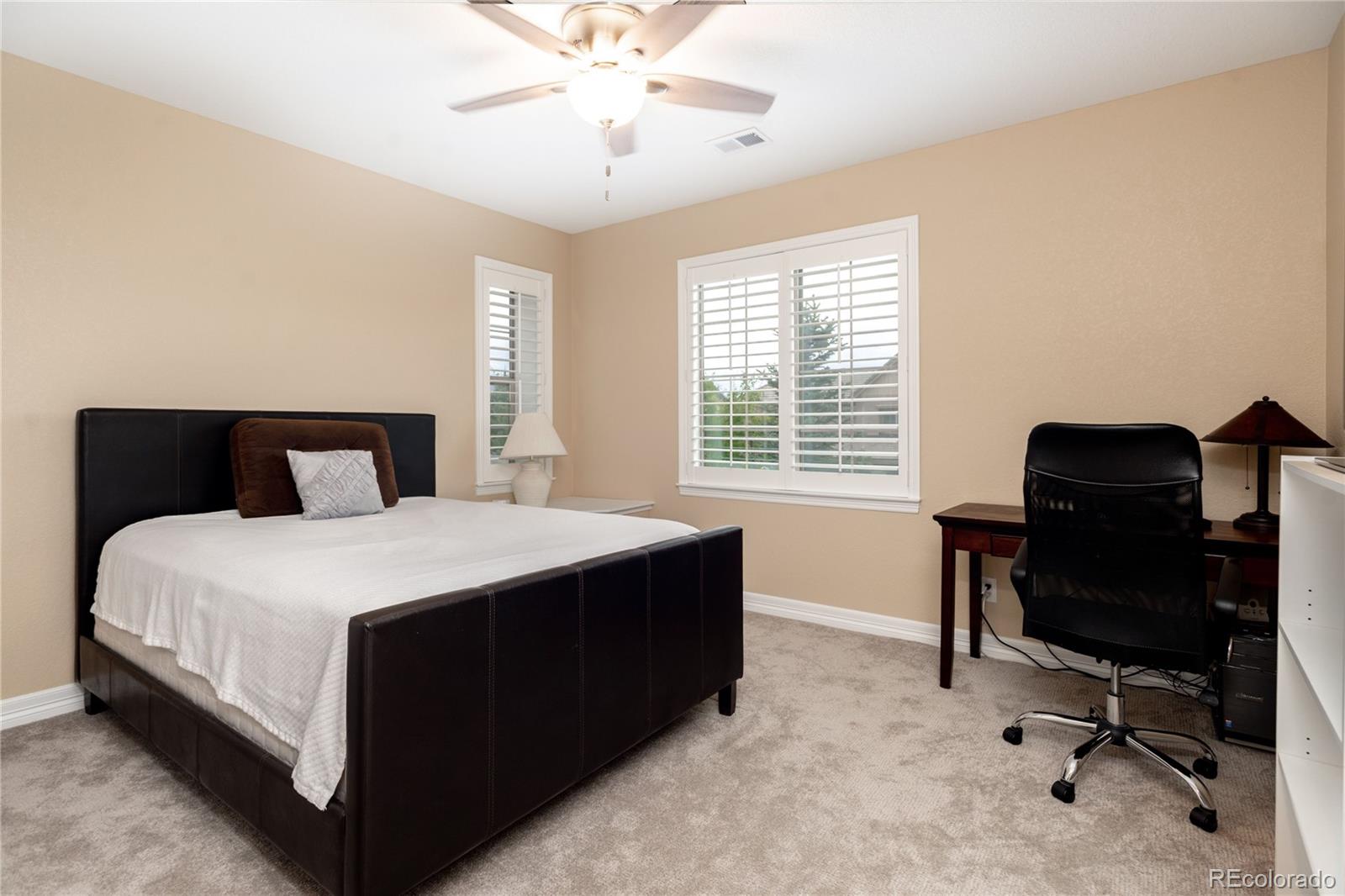 10599 Sundial Rim Road Highlands Ranch, CO 80126 - Photo 32 of 40 a bedroom with a bed and a desk