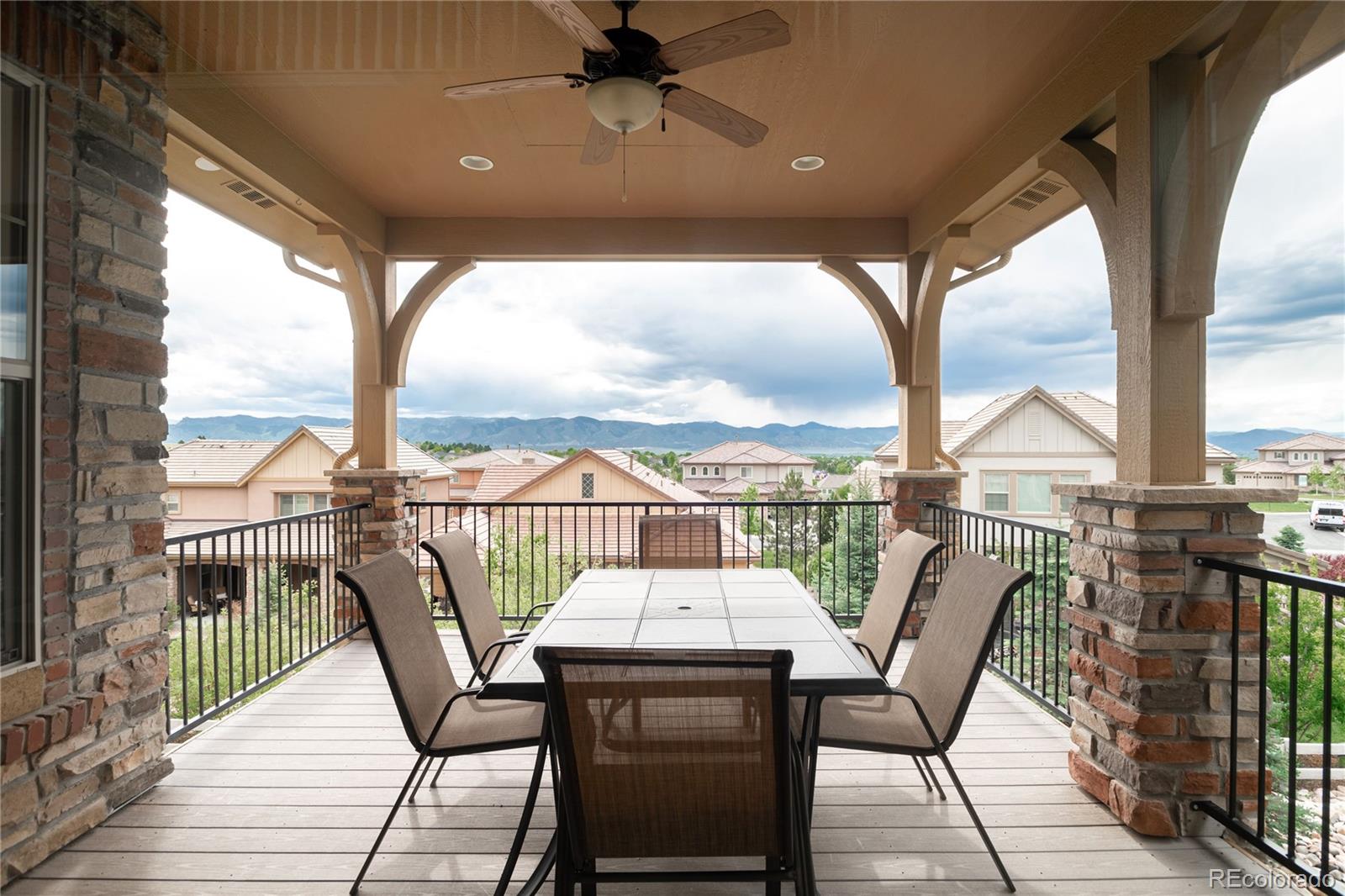 10599 Sundial Rim Road Highlands Ranch, CO 80126 - Photo 34 of 40 a view of a balcony with furniture and wooden floor