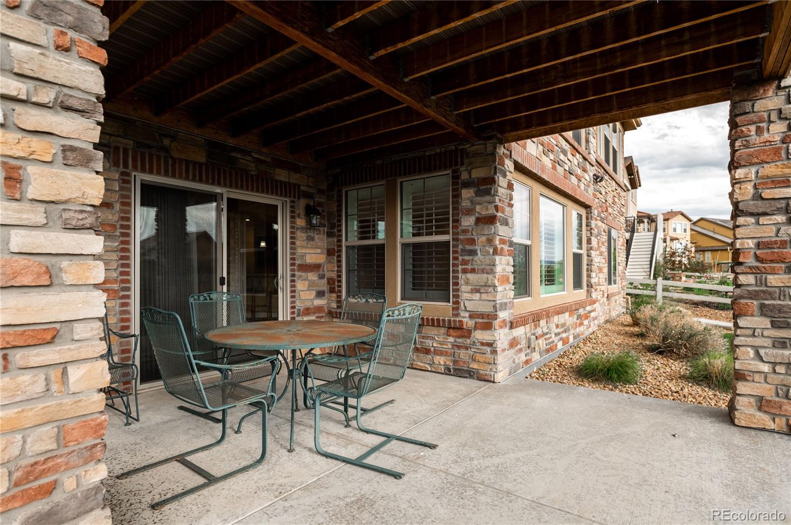 10599 Sundial Rim Road Highlands Ranch, CO 80126 - Photo 35 of 40 a patio with table and chairs and potted plants