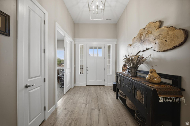 2829 East 1880th Street South St. George, UT 84790 - Photo 8 of 54 Entryway featuring light wood-style floors and a chandelier