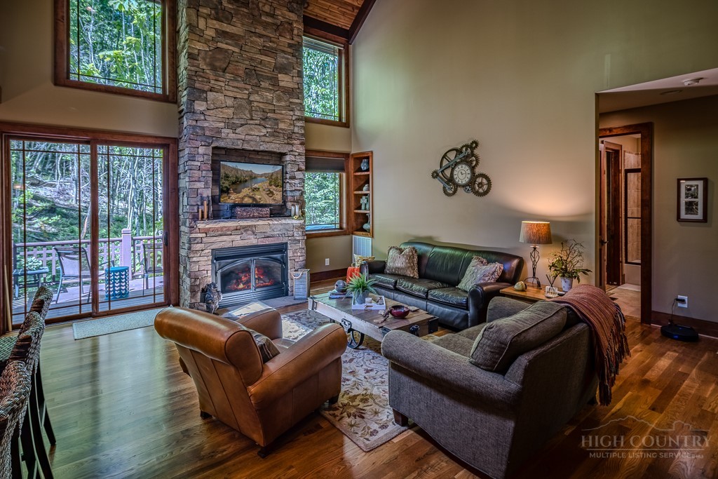 485 Woodlake Loop Road Elk Park, NC 28622 - Photo 4 of 44 a living room with furniture a fireplace and a large window