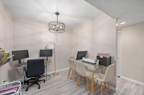 a view of a workspace with furniture and wooden floor
