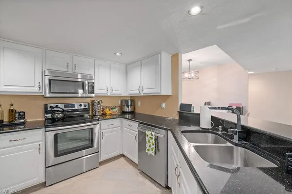 a kitchen with a sink stove and microwave