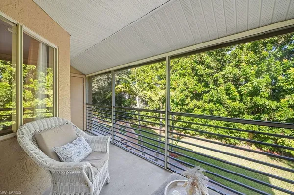 a living room with large trees and furniture