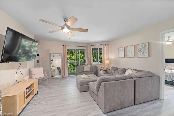 a living room with furniture and a flat screen tv