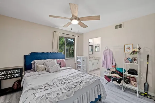 a bedroom with bed and a chandelier