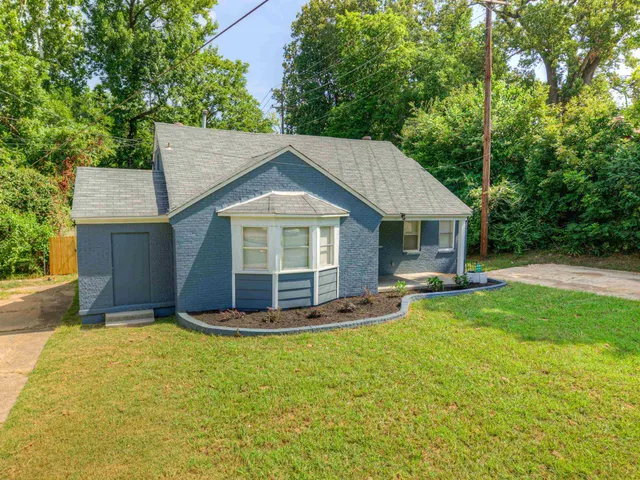 a front view of house with yard and green space
