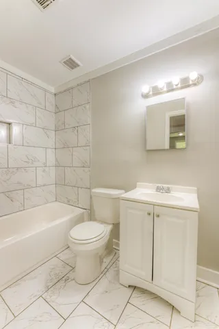 a bathroom with a sink a toilet and a bathtub
