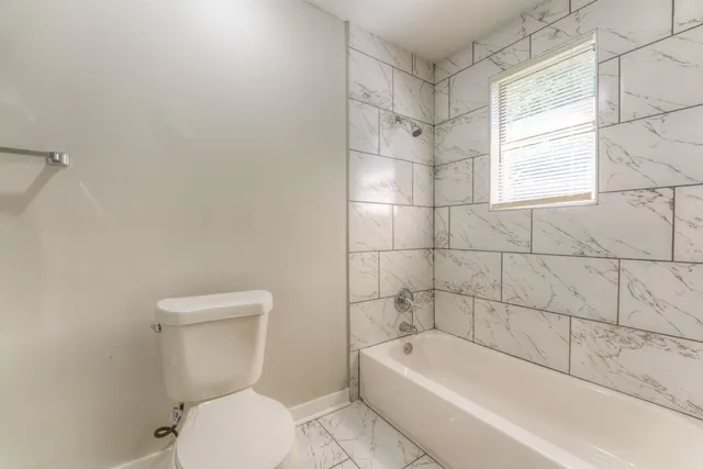 a bathroom with a toilet a sink and bathtub