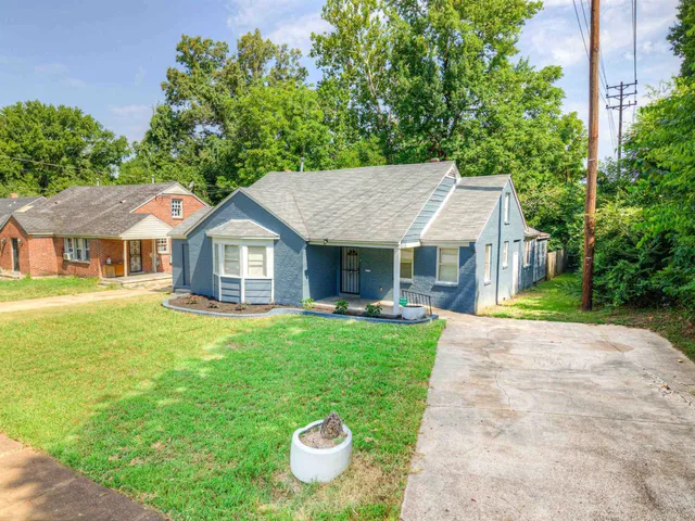a front view of a house with a garden and porch