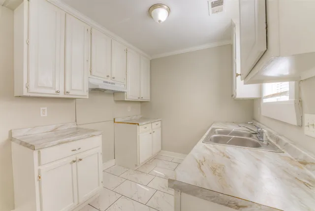 a kitchen with white cabinets