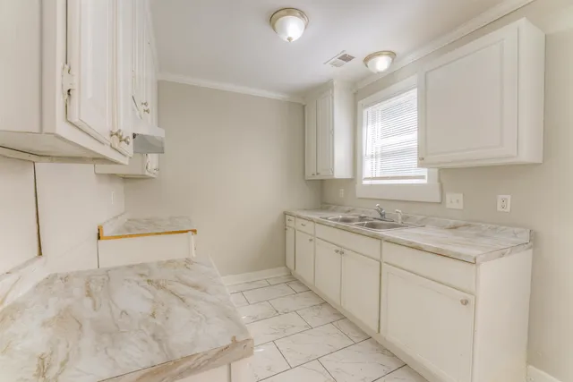 a kitchen with granite countertop a sink and a stove