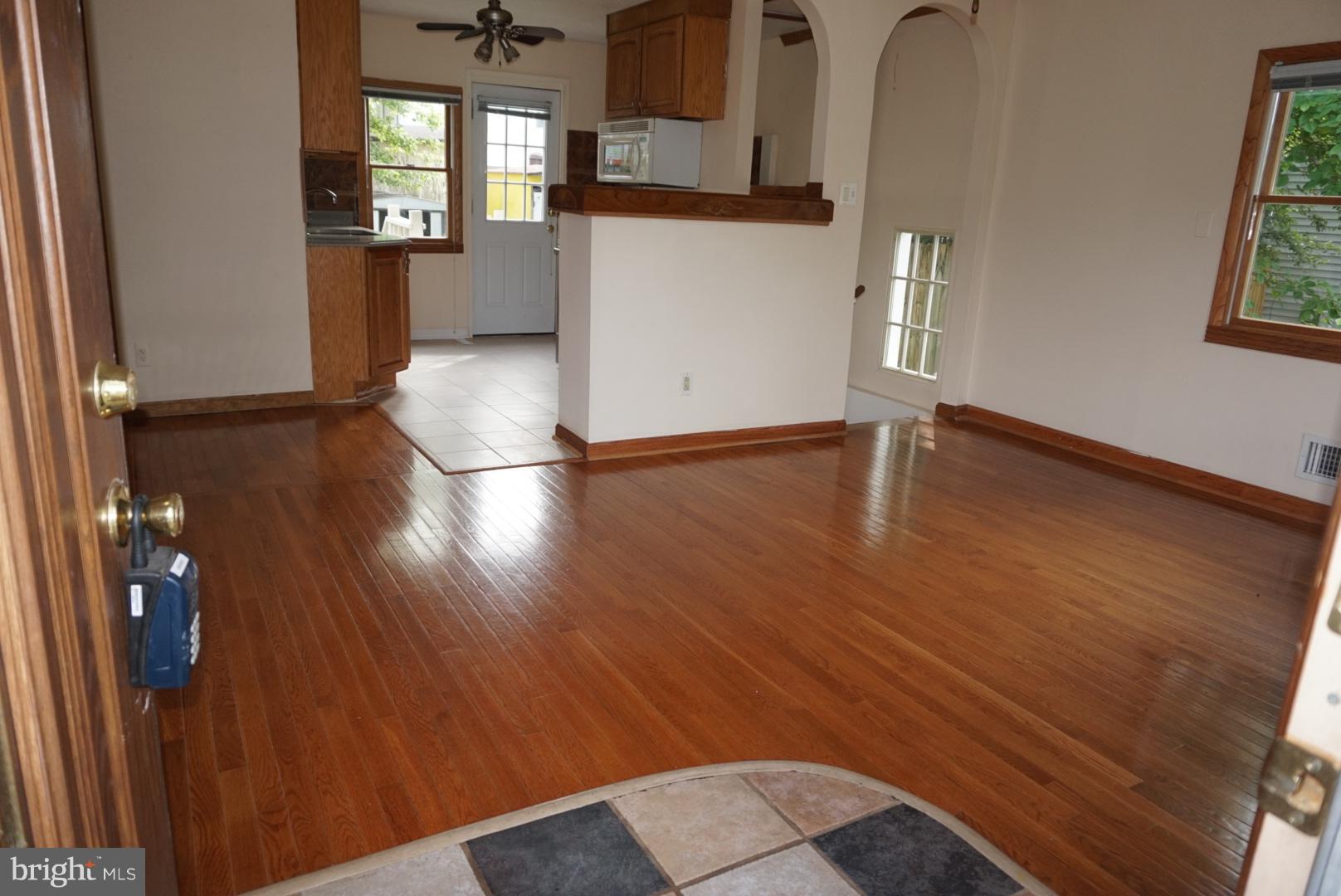 11505 Goodloe Road Silver Spring, MD 20906 - Photo 3 of 25 wooden floor in an empty room with a window