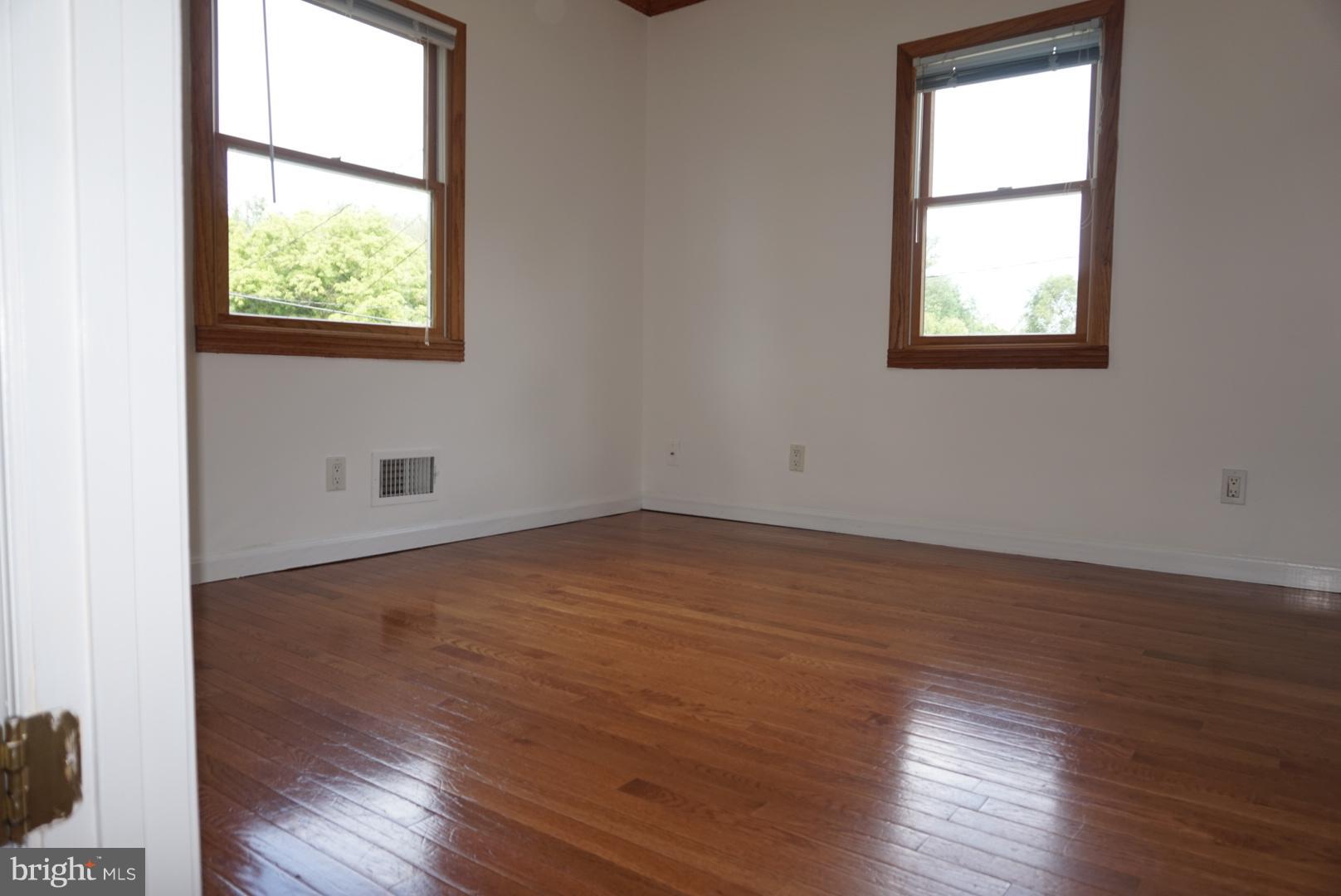 11505 Goodloe Road Silver Spring, MD 20906 - Photo 21 of 25 an empty room with wooden floor and windows