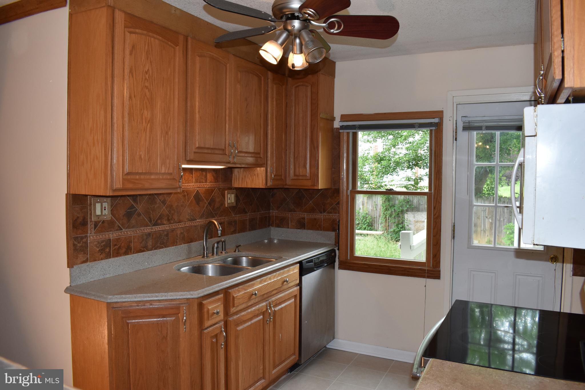11505 Goodloe Road Silver Spring, MD 20906 - Photo 4 of 25 a kitchen with a sink cabinets and window