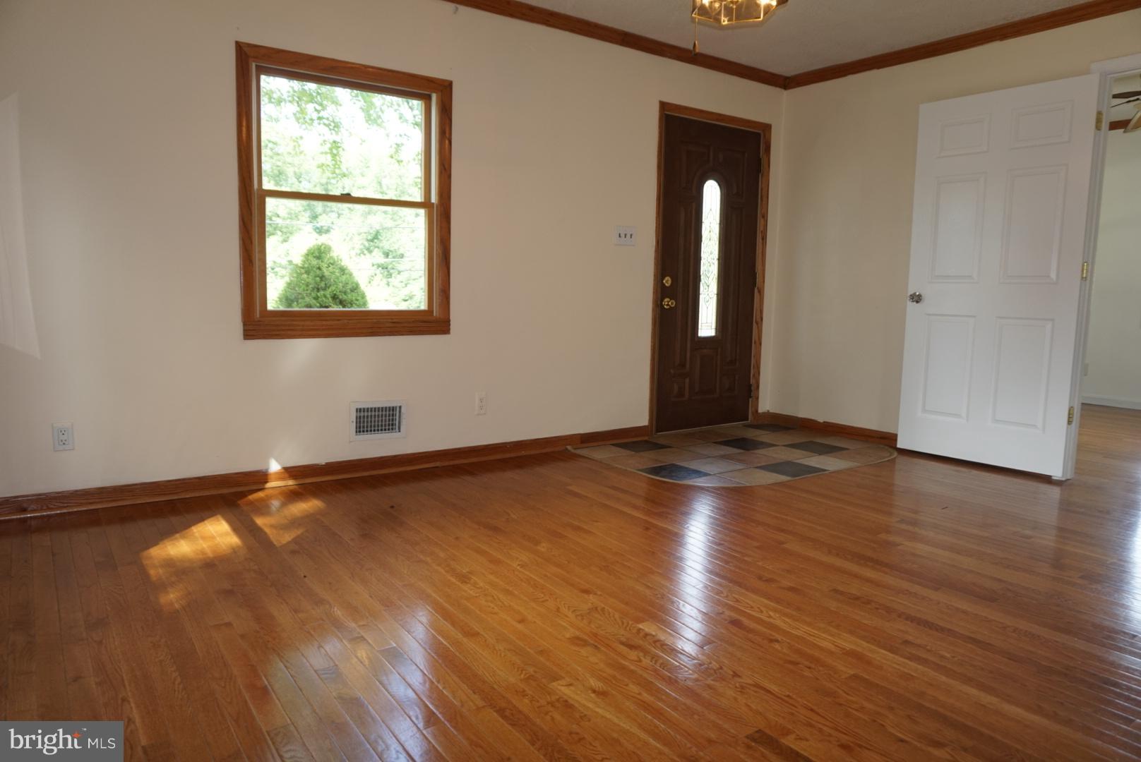 11505 Goodloe Road Silver Spring, MD 20906 - Photo 8 of 25 an empty room with wooden floor and windows