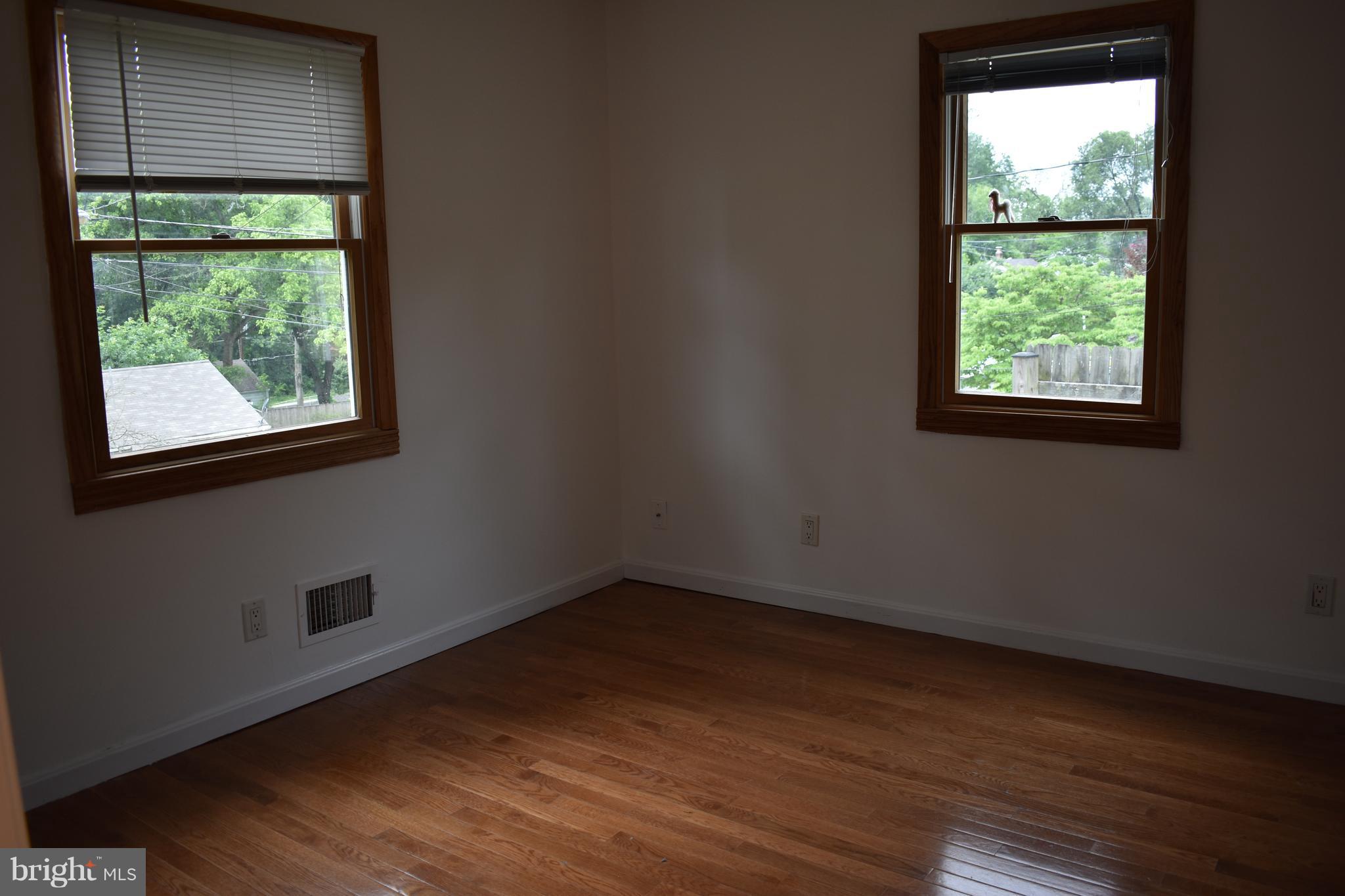 11505 Goodloe Road Silver Spring, MD 20906 - Photo 9 of 25 an empty room with wooden floor and windows