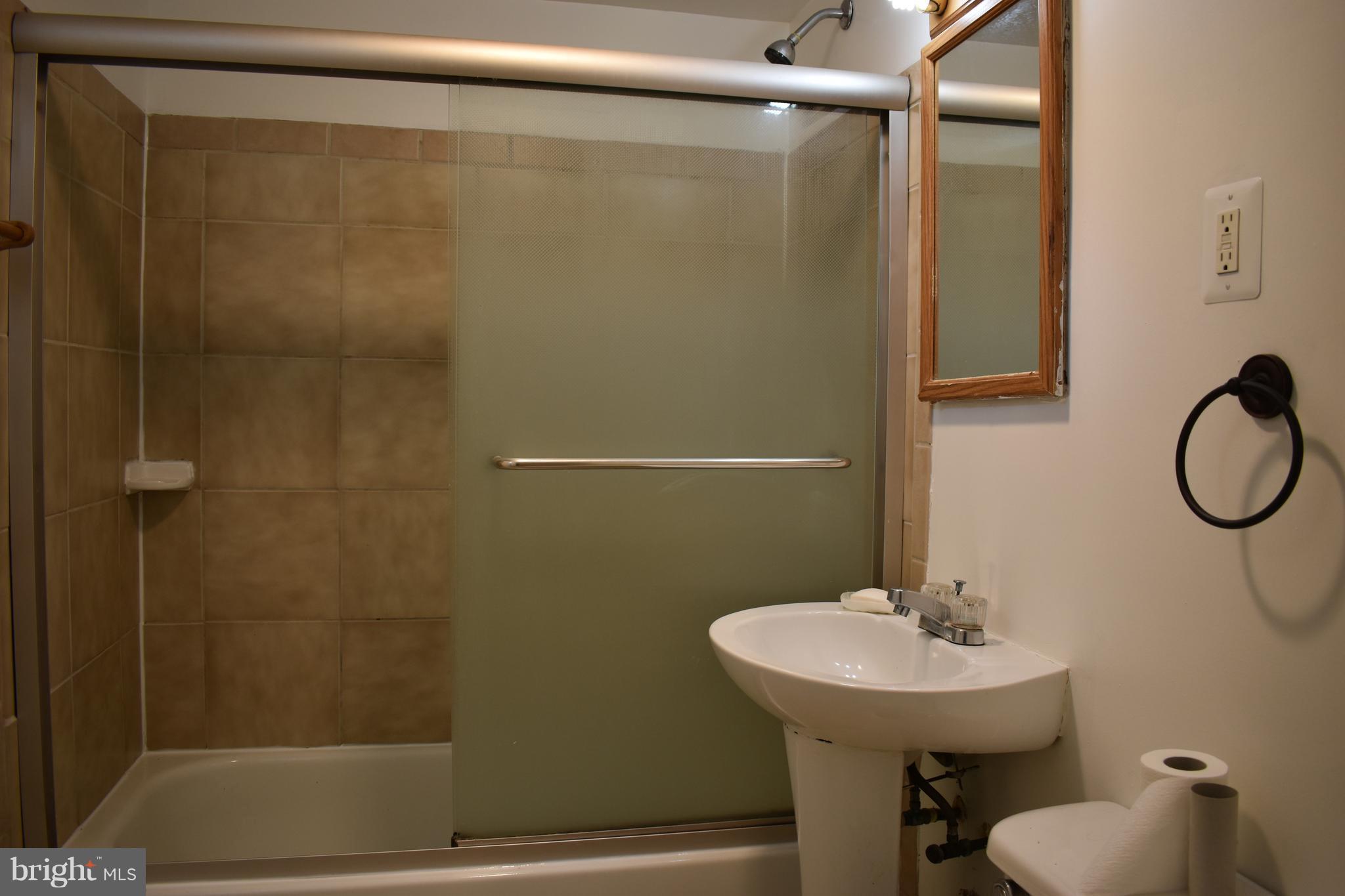 11505 Goodloe Road Silver Spring, MD 20906 - Photo 10 of 25 a bathroom with a sink a toilet and shower