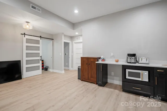 a kitchen with stainless steel appliances kitchen island granite countertop a refrigerator and a sink