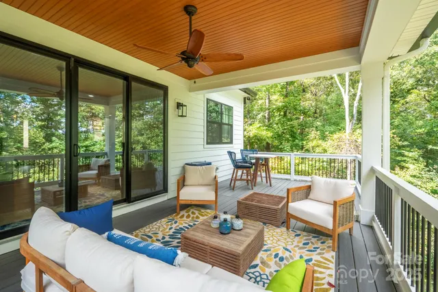 a living room with furniture and a floor to ceiling window