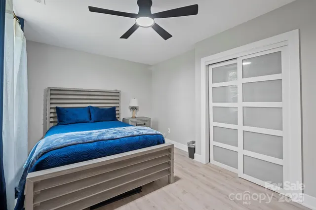 a bedroom with a large bed and a flat tv