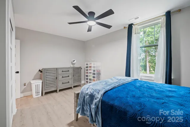a bathroom with a toilet sink vanity tub and mirror