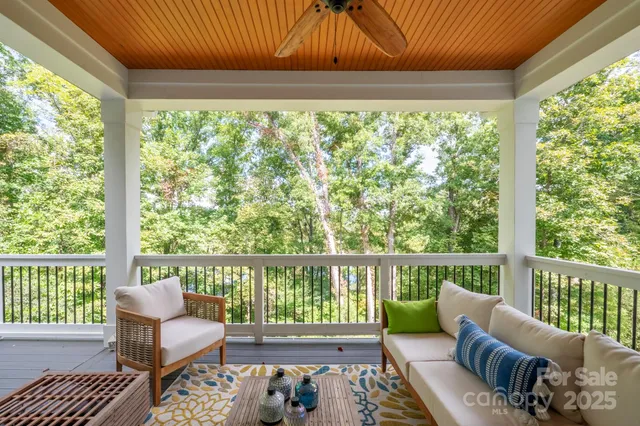a view of balcony with wooden floor and outdoor seating